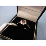 AN 18CT WHITE GOLD RUBY AND DIAMOND CLUSTER RING