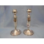 A pair of hall marked silver candlesticks