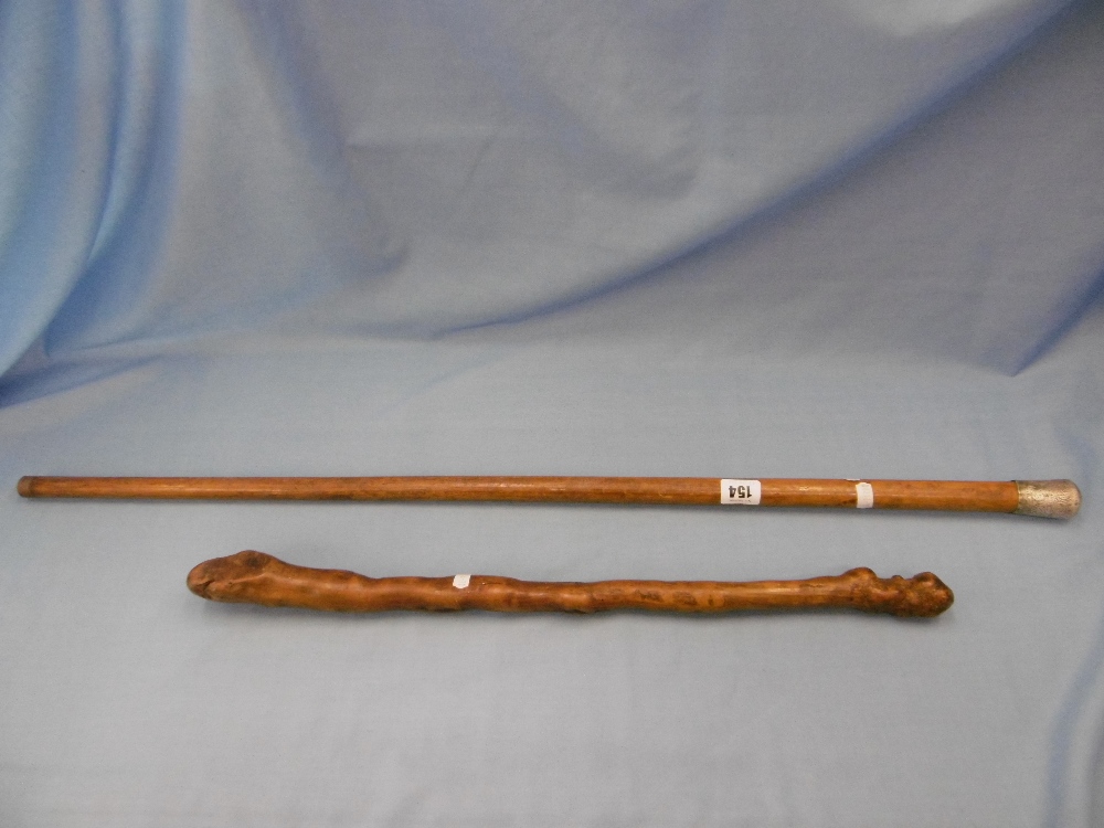 A silver topped cane and Shilalee