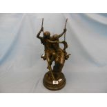 A bronze sculpture of a boy & girl on a swing