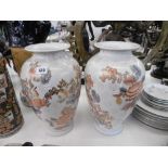 A pair of orange & white vases