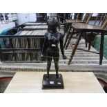 A bronze sculpture of madam whiplash