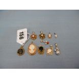 TEN ASSORTED GOLD PENDANTS