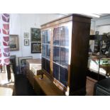 A walnut bookcase on Queen Anne feet,