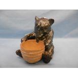 A Doulton Lambeth bear with honey pot possible modeled by Mark Marshall,