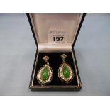 A pair of drop earrings set with Cabochon jade onyx and diamonds