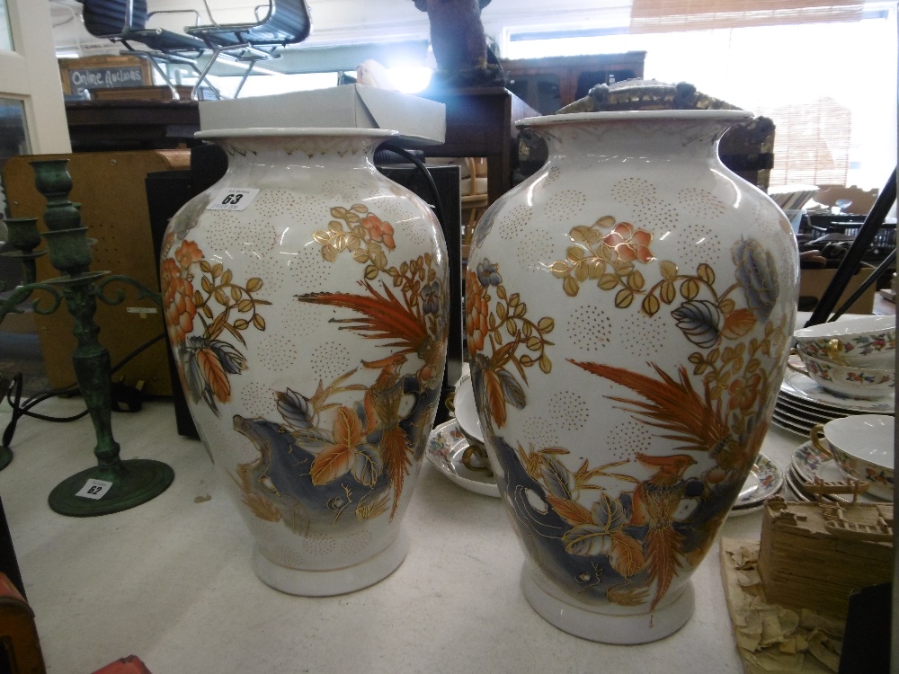 A pair of orange & white vases