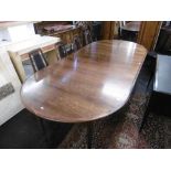 A mid century Danish rosewood dining table, with three extra leaves