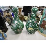 A pair of Chinese green ground gourd shaped vases,