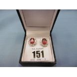 A pair of 18ct white gold treated ruby and diamond cluster stud earrings, total carat weight 5.