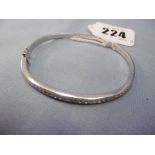 An 18ct white gold and diamond bangle