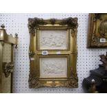 A pair of cherub plaques in gilt frame