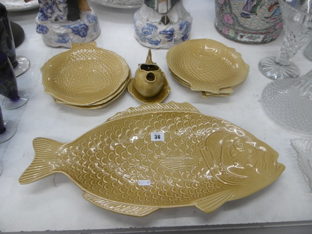 A four place setting Shorter yellow pottery fish set, side plates,