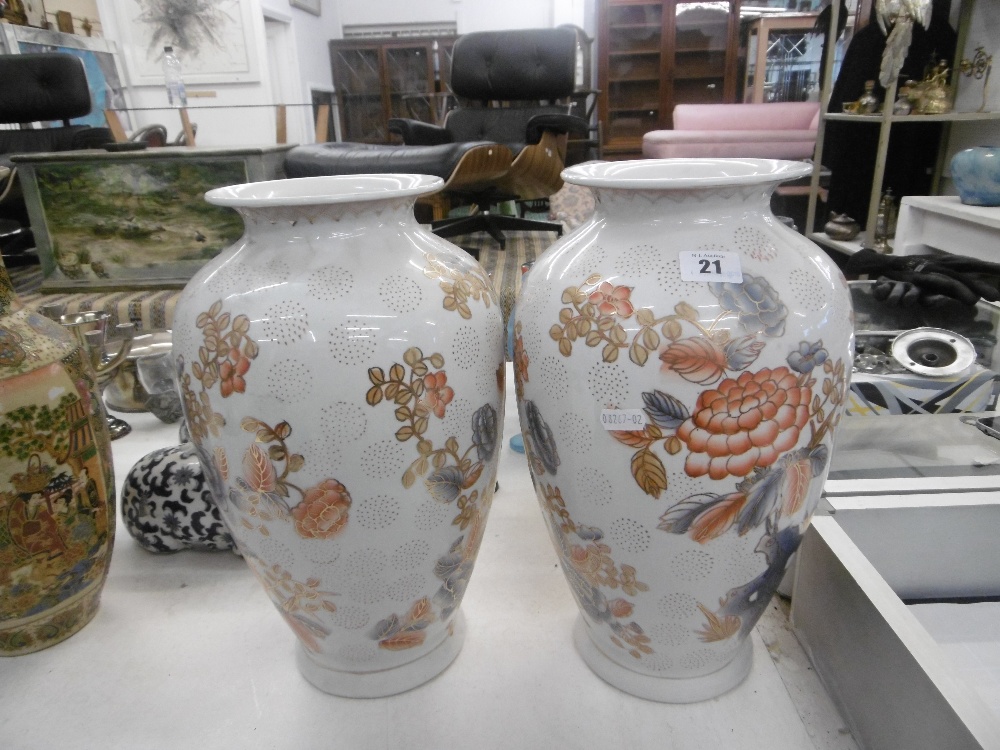 A pair of orange & white vases