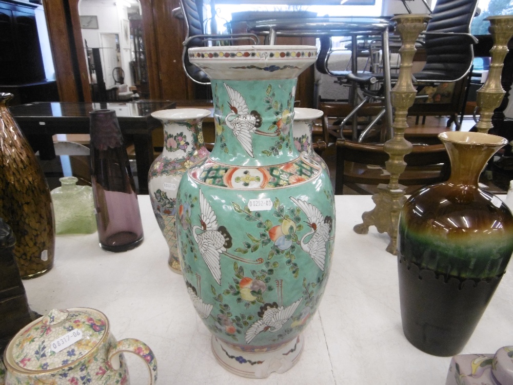 An oriental green vase decorated with storks & blossoming fruit A/F