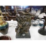 A bronze abstract sculpture " the holocaust" mounted on green marble plinth,