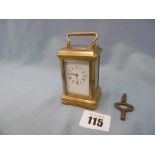 A miniature gilt brass carriage clock