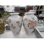 A pair of orange & white vases
