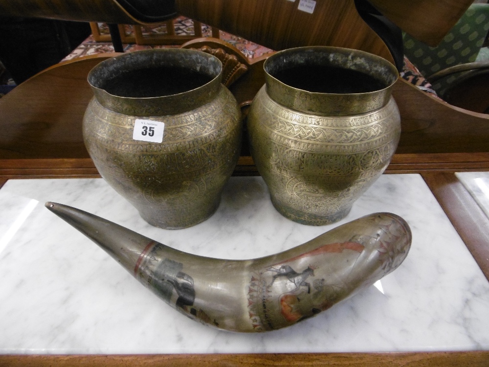 A pair of indo Persian brass pots and a Argentinean horn decorated with gauchos and crests