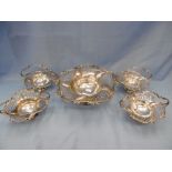 A set of four hallmarked pierced silver baskets and a matching pierced silver tazza,