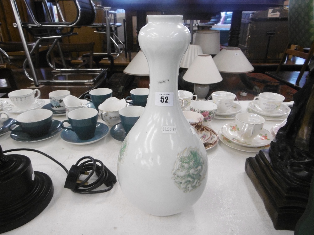 A Chinese cream ground porcelain gourd shaped vase with enamel dragon decoration,