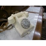 A cream Bakelite phone with drawer
