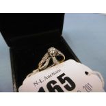 An 18ct gold diamond and solitaire ring with diamond shoulders,