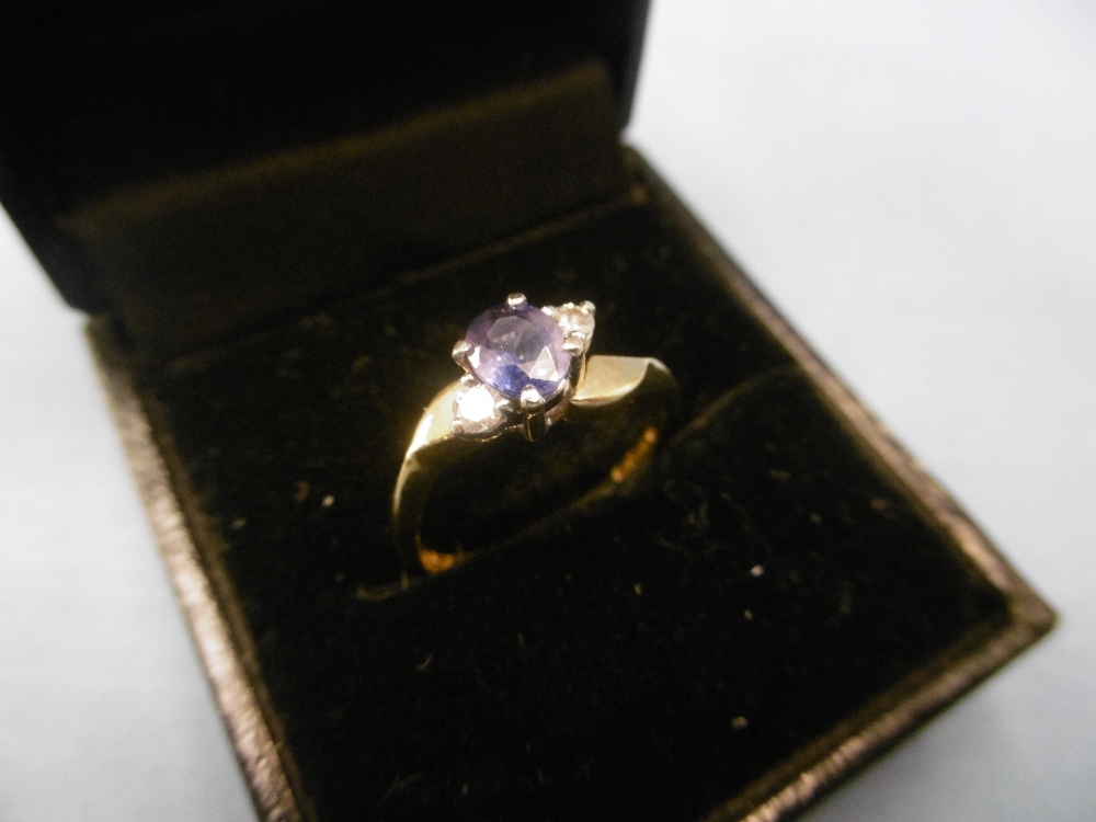 An 18ct gold sapphire and diamond three stone ring size m