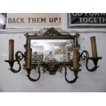 A French style brass four arm mirrored wall sconce