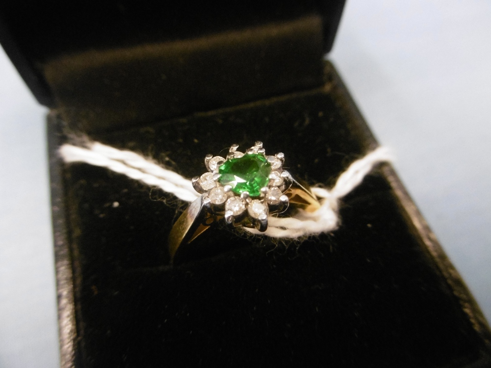 An 18ct gold green garnet and diamond cluster ring size m