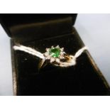 An 18ct gold green garnet and diamond cluster ring size m