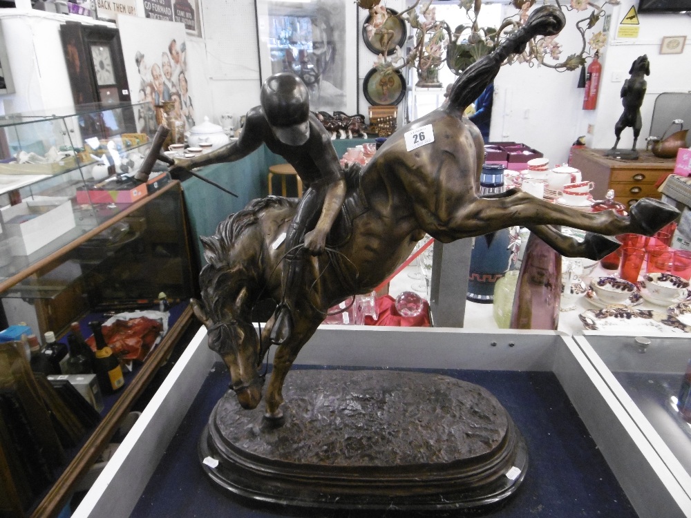 A large bronze sculpture of a polo player