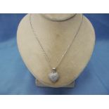 A 9ct white gold diamond heart shaped pendent on chain,