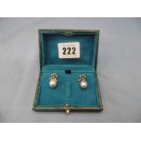 A pair of pearl drop earrings set with diamond bow tops