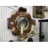 A copper and brass wall mirror,