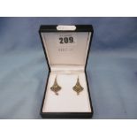 A pair of drop earrings set with peridot,