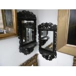 A pair of decorative wall mirrors