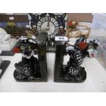 A pair of vintage glazed terracotta figural book ends,