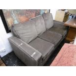 A brown three seater sofa