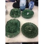 A quantity of 19th century green Majolica salad dishes including Davenport and Wedgewood