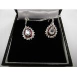 A pair 18ct white gold diamond and ruby drop earrings, rose cut centre stones 1.