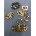 Four hallmarked silver belt buckles and a Victorian white metal and paste belt buckle