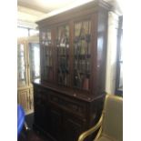 A 19th century secretaire bookcase with books