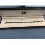 A treated sapphire and diamond 18ct white gold line bracelet 17.