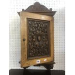 A carved wall cupboard