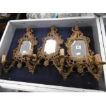 A set of three gilt metal rococo style wall sconces