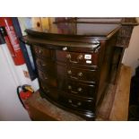 An inlaid mahogany bow fronted chest of five drawers with brush slide