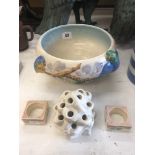 A Clarice Cliff bowl, centre piece and two napkin rings (one a.