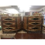 A fine quality pair of demi lune cabinets inlaid and cross banded with ebony on walnut,