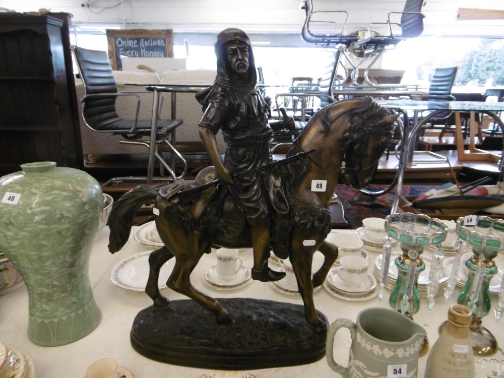 A bronze sculpture of an Arabian horseman